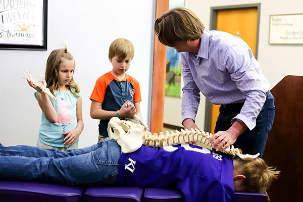 Dr. Wes Nyberg teaching pediatric patients about chiropractic care