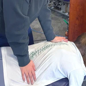A patient receiving a back adjustment