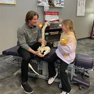 Wes Nyberg explaining spine health to a pediatric patient